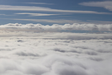 beautiful white clouds on blue sky, view from airplane window