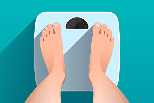 Top view of feet of woman standing on bathroom scales