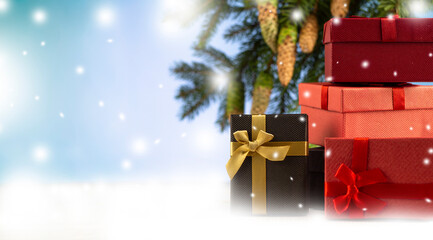 gift box. Many boxes for congratulations. A Christmas gift. Spruce branches with cones in the snow and gifts. Copyspace