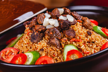 Tagine with traditional uzbek pilaf. Close up