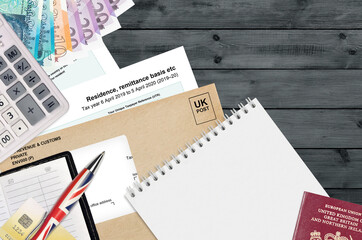 English Tax form sa108 Residence remittance basis etc from HM revenue and customs lies on table...