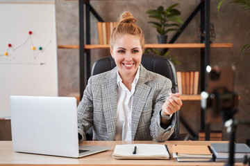 Fototapeta premium Positive entrepreneur having video call and smiling