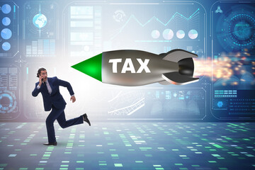 Concept of tax with businessman chased by rocket