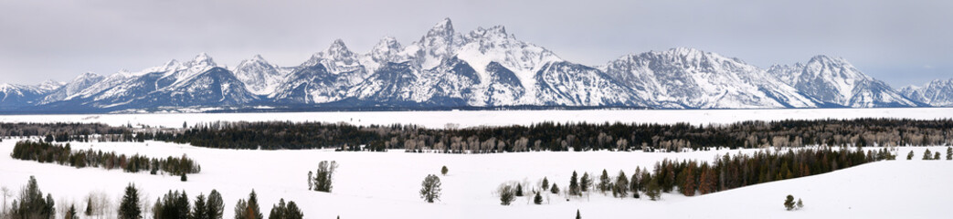 Wide panorama of the Grand Teton peaks in winter from Teton Point turnout Jackson Hole