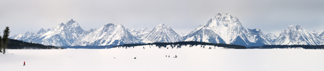 Panorama of Ice fishing on Jackson Lake with Grand Teton peaks and Mount Moran Wyoming