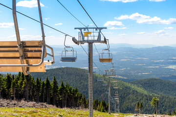 An empty ski lift not operating during summer at the Mt Spokane State Park ski resort overlooking...