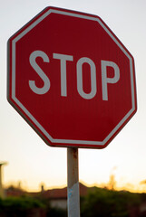 Stop sign against the sky and houses