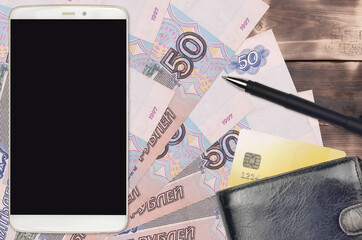 50 russian rubles bills and smartphone with purse and credit card. E-payments or e-commerce...