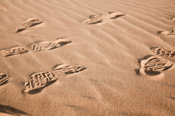 Fototapeta na wymiar Trekking shoes footprints in Merzouga desert, Morocco