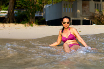 Woman in bikini pretty sit happy with wave