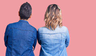 Couple of women wearing casual clothes standing backwards looking away with crossed arms
