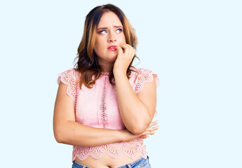 Young beautiful caucasian woman wearing casual clothes looking stressed and nervous with hands on mouth biting nails. anxiety problem.
