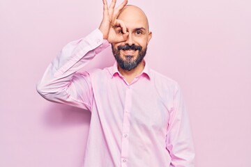 Young handsome man wearing business clothes smiling happy doing ok sign with hand on eye looking through fingers