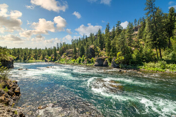The Spokane River rapids near the Bowl and Pitcher area of Riverside State Park as the sun starts to set in Spokane, Washington