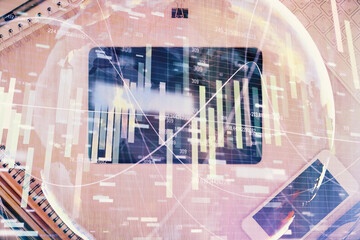 Double exposure of business theme hologram over desktop with phone. Top view. Mobile international trade connection concept.