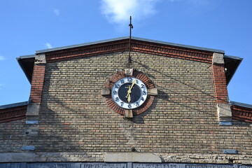 Clock on old factory brickwork