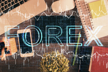 Double exposure of forex chart hologram over desktop with phone. Top view. Mobile trade platform concept.