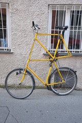 Fototapeta na wymiar Tall yellow bike with multiple frames