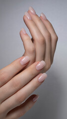 beautiful hands with manicured nude nails manicure