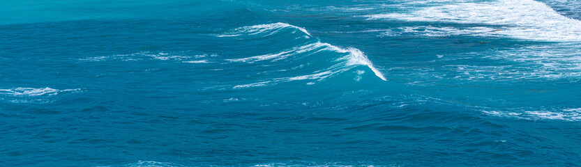 horizontal panoramic shot of blue water wave surface backround 