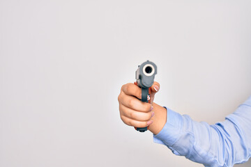 Hand of caucasian young woman holding gun over isolated white background