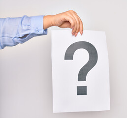 Hand of caucasian young woman holding paper with question mark symbol over isolated white background