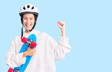 Beautiful brunette young woman wearing safety helmet and skate screaming proud, celebrating victory and success very excited with raised arms