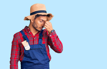 Handsome latin american young man weaing handyman uniform tired rubbing nose and eyes feeling...