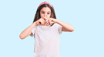 Cute hispanic child girl wearing casual white tshirt rejection expression crossing fingers doing negative sign