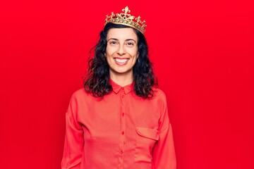 Fototapeta premium Young beautiful hispanic woman wearing princess crown with a happy and cool smile on face. lucky person.