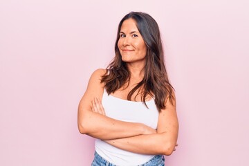 Young beautiful brunette woman wearing casual sleeveless t-shirt over white background happy face...