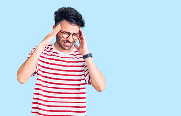 Young hispanic man wearing casual clothes with hand on head, headache because stress. suffering migraine.