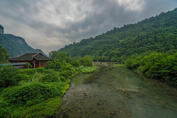 Fototapeta na wymiar River flowing through karst mountain scenery in China