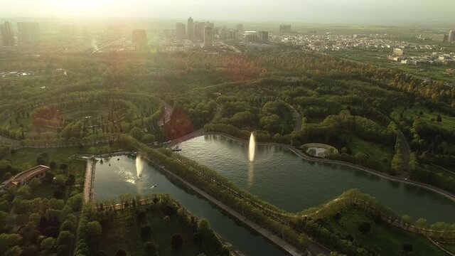 Aerial view of the city of Erbil with trees, skyscrapers and park.