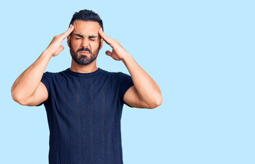 Young hispanic man wearing casual clothes suffering from headache desperate and stressed because pain and migraine. hands on head.