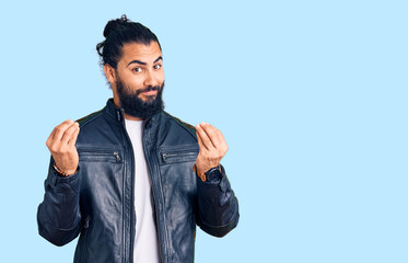 Young arab man wearing casual leather jacket doing money gesture with hands, asking for salary...