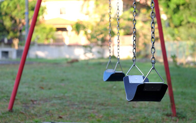 Swing set at a playground that is empty