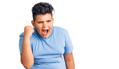 Little boy kid wearing sports workout clothes angry and mad raising fist frustrated and furious while shouting with anger. rage and aggressive concept.