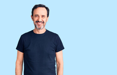 Obraz premium Middle age handsome man wearing casual t-shirt with a happy and cool smile on face. lucky person.