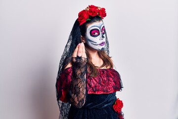 Young woman wearing day of the dead costume over white doing italian gesture with hand and fingers confident expression