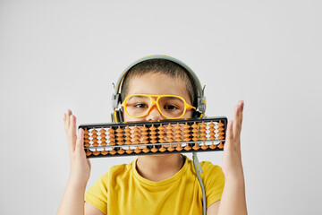 Schoolboy with abacus. Young kid training mental arithmetic - complex process that includes number...