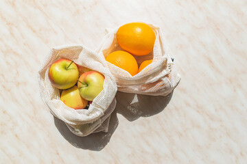 Fruit in cotton shoppers. Zero waste. Eco friendly shopping. Shadow concept