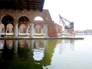 Venice, Arsenal docks with arched passages and an port crane