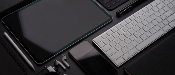 Digital devices with tablet, smartphone, keyboard and accessories on workspace