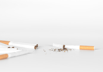 broken cigarette and group  of cigarettes on white background with copy space from top view. World No Tobacco Day Tobacco and lung health concept .
