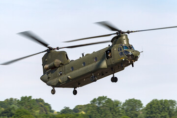 Large twin rotor military helicopter coming in to land.