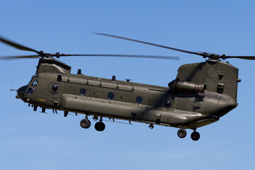 Large twin rotor military helicopter coming in to land.