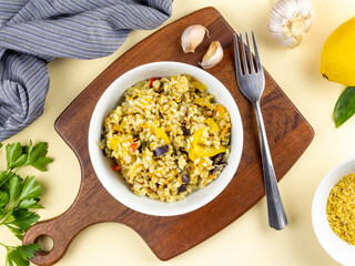 Vegetarian pilaf from cereal and vegetables in bowl. Concept of healthy nutrition. Top view.