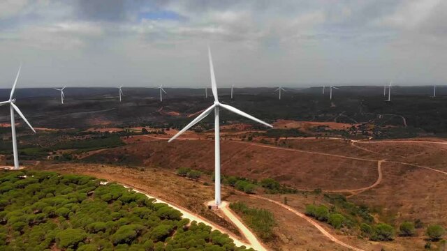 Aerial Dolly Shot Approaching A Wind Farm In Barao De Sao Joao, Portugal.