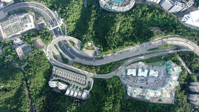 Hong Kong express highway traffic with Residential buildings and green nature surroundings, Aerial view.
